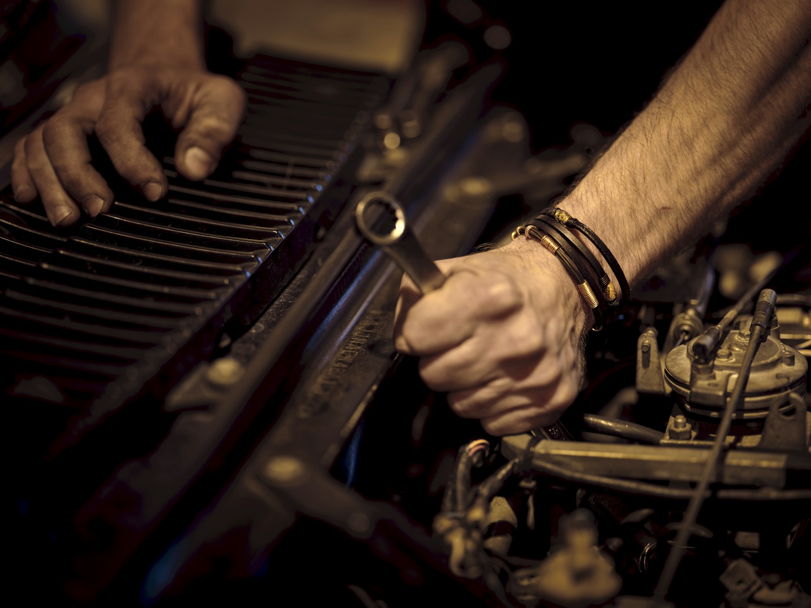 Automotive maintenance work under a car hood